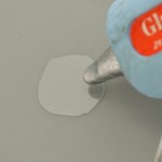 Using glue gun, glue eggs to circle